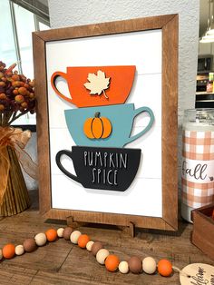 there is a sign that says pumpkin spice and two cups on top of each other