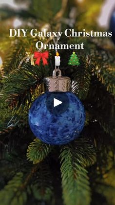 a blue ornament hanging from a christmas tree