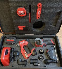 a tool box filled with tools on top of a wooden floor