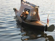 a small boat with people in it floating on the water