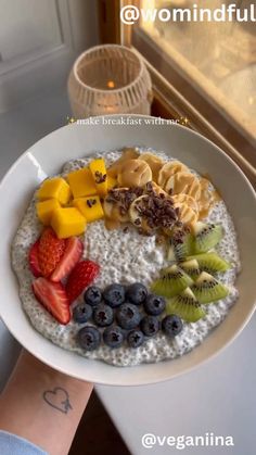 a white plate topped with oatmeal and fruit