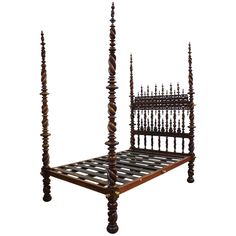 an antique wooden bed frame with metal posts and headboard made out of chess pieces