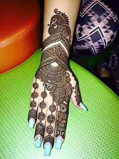 a henna tattoo is on someone's hand