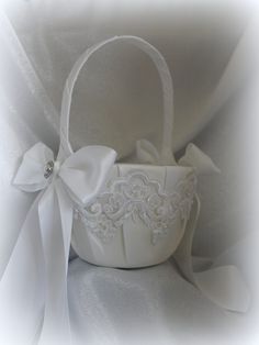 a white basket with a bow on it