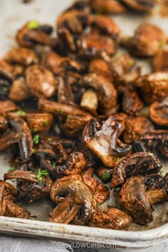 cooked mushrooms in a baking dish with parsley