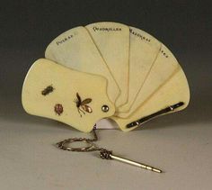 four wooden tags with bugs on them and a keychain hanging from the back