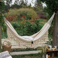 a hammock hanging in the middle of a garden