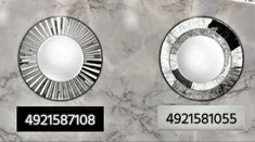 two round mirrors sitting on top of a marble wall next to each other with numbers below them