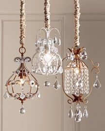 three chandeliers hanging from the ceiling with beads and crystal drops on them,