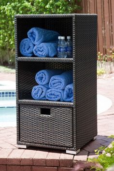 three tiered storage unit with blue towels