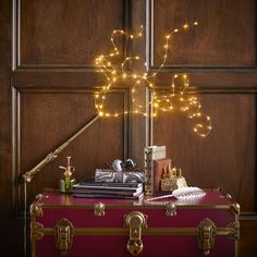 a trunk with some lights in it and other items on the table next to it