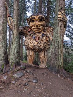 a wooden statue made to look like a creature in the woods