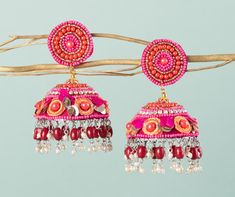 Our Indian earring is silver plated, created with careful attention to detail. The color combination and finishing give it an elegant look & feel. This design is perfect for parties & functions as these handcrafted earrings are specially designed for Indian beautiful brides -Base Metal- Alloy, Silver, Brass -Plating- Silver -Stone- Pearls, Beads & sequin -Sizing-Non Adjustable -Type- Jhumkas Earrings -Light Weight -Color- Multi -FREE Shipping -Gift Wrapping Available -Delivery from a Small Busin Festive Fusion Danglers With Dangling Beads, Fusion Style Latkans Chandelier Earrings For Celebration, Diwali Fusion Style Chandelier Earrings With Latkans, Handmade Fusion Bridal Earrings For Celebration, Fusion Style Danglers For Festivals And Celebrations, Festive Celebration Fusion Danglers, Handmade Fusion Danglers For Diwali, Fusion Style Chandelier Earrings For Festivals, Pink Fusion Danglers For Festivals