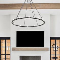 a large flat screen tv mounted above a fireplace