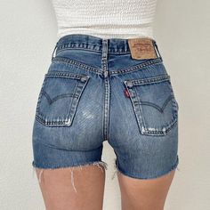 Vintage 501 Medium Wash Distressed Levi's Cutoff Shorts//27" waist, 10.75" rise, 4" inseam, 34.5" upper hip, 39.5" hips, 22" thigh! Would fit a size 26 best imo, or maybe a 26/27 if you want them on the snugger side, but check your measurements and ask me questions. Great quality 100% cotton denim and these actually hug your booty! They have awesome wear and fading with light distressing and a patched seat that adds great character! Price firm We ship internationally! SVS00477 Vintage 501, Cutoff Shorts, Cut Off Shorts, Cut Off, Short Outfits, Levi's, Womens Bottoms, Bathing Beauties, Womens Shorts