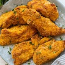 some fried chicken is on a plate with broccoli