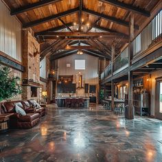 a large living room filled with furniture and a fire place in the middle of it