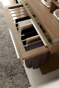 an open drawer on the side of a wooden cabinet in a room with carpeted flooring