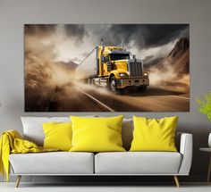 a yellow semi truck driving down the road with dramatic clouds in the sky behind it