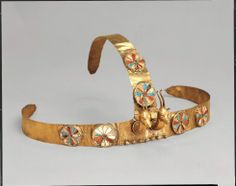 an old gold bracelet with colorful stones and bells on the side, possibly made in india