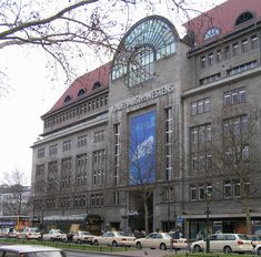 cars are parked in front of a large building