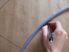 a person is writing on a piece of cardboard