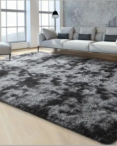 a living room with a large rug on the floor