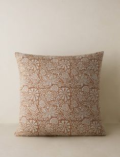 a brown and white pillow sitting on top of a table