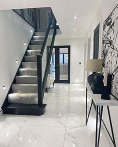 a white marble floor and stairs in a house