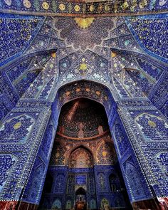 the inside of an ornate building with blue tiles