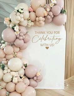 balloons and flowers are arranged in the shape of a letter with thank you for celebrating with us