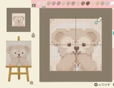 there is a cross stitch teddy bear on the wall next to an easel and some pictures