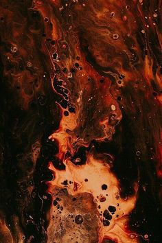 an abstract painting with red, black and orange colors on it's surface is shown in close up