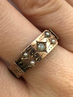 A Victorian 9ct gold pearl mourning ring. This ring is Hallmarked Chester, with the date mark of 1888. The largest pearl is set at the centre of the ring, and measures 3 x 3mm's. Set in to each corner of the central section are four round seed pearls which each measure 2 x 2mm's. The centre piece takes the form of a buckle, and around the ring there are detailed gold belt loops. Beneath the loops there is a ring of fine hair that has been very carefully and delicately platted. An excellent and meaningful example of Victorian sentiment. Finger size Q and a half. Unfortunately we are unable to re-size this ring. Unique Vintage Jewelry, Gold Edwardian Engagement Ring, Statement Gold Rings, 1800s Engagement Ring, 1920s Rings, Edwardian Rings, 1800s Jewelry, Ring With Pearls, Antique Gold Ring