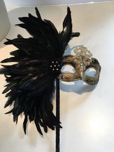 Black Feather mask- Masked ball- New Years Eve- Save Venice -Masquerade Ball- Mardi Gras Mask -Halloween Masked Ball Hello, Perfect for a masquerade party- birthday celebration, or New years eve celebration. This black coque feather rhinestone / sequin gold mask is made with tie. The feathers are about 8 inches. Can be made in: Gold and black mask Solid black mask Silver and black mask Cardboard molded over plastic mask/ makes it durable and then its painted. Custom colors available. Can be made Fantasy Eye Mask For Halloween Masquerade, Halloween Eye Mask For Costume, Halloween Eye Masquerade Mask, Halloween Eye Mask For Costume Party, Halloween Masquerade Eye Mask, Gothic Masks For Halloween And Masquerade, Halloween Costume Party Eye Mask, Halloween Masquerade Full Face Costume Accessories, Full Face Halloween Masquerade Costume Accessory