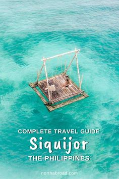 a small wooden structure floating in the ocean with text overlay reading complete travel guide siquior the philippines