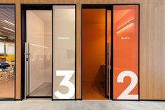 an office building with glass doors and numbers on the front door, in which there is a meeting room