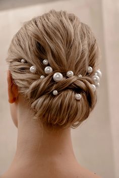 a woman's hair with pearls in it