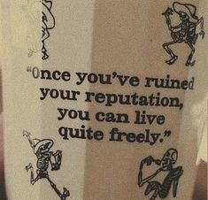 there is a coffee cup that has some drawings on the side of it with words in black and white