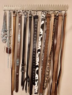 a bunch of belts hanging on a wall