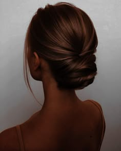 a woman with her hair in a low bun