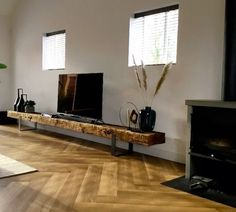 a living room filled with furniture and a flat screen tv on top of a wooden table