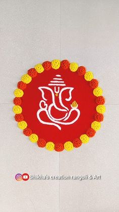 a red and yellow mat with an image of a ganeshi in the middle