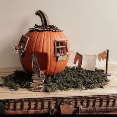 there is a fake pumpkin in the shape of a house