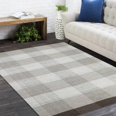 a living room with a white couch and checkered rug