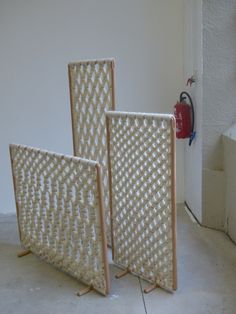 two pieces of woven material sitting next to each other on top of a cement floor