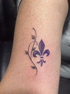 a woman's arm with a purple flower tattoo on the left side of her body