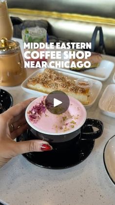 a woman is holding a bowl with food in it on the table next to other dishes