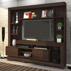 a living room with a large tv and entertainment center