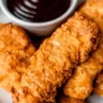 air fryer chicken tenders on a plate with dipping sauce